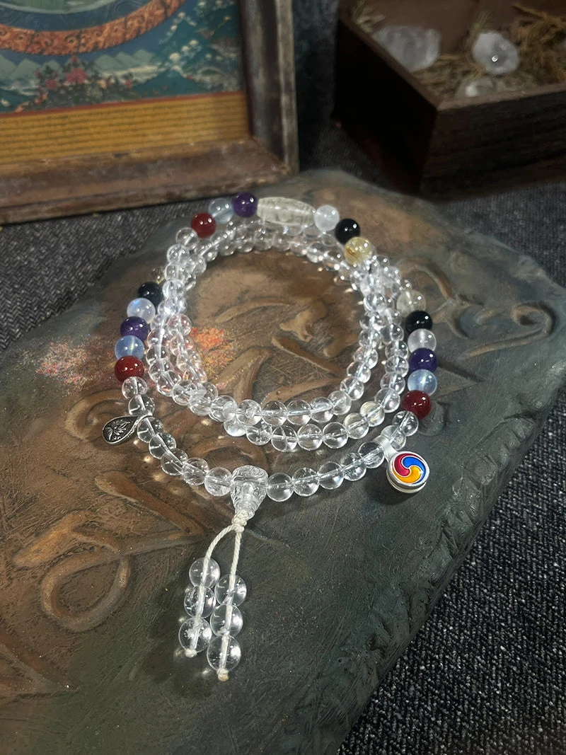 Stack of beaded bracelets with colorful beads on a textured surface