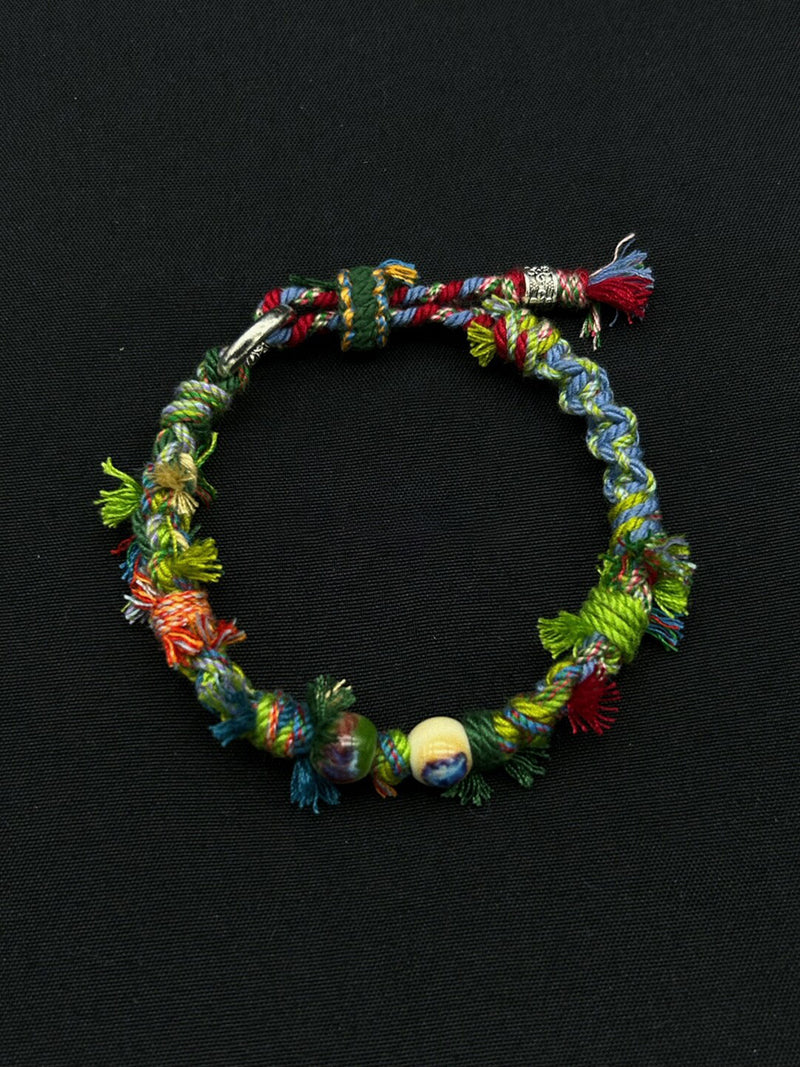 Colorful braided bracelet on a black background